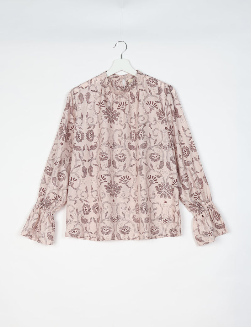 Beige blouse with brown tropical floral pattern, long sleeves with gathered cuffs, and keyhole neckline, hanging on white hanger