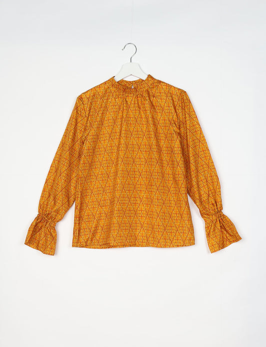 Flowing blouse with peasant sleeves and gathered neckline made from upcycled garments and repurposed clothing, showcasing eco clothing and fair trade fashion in a stylish, comfortable design.