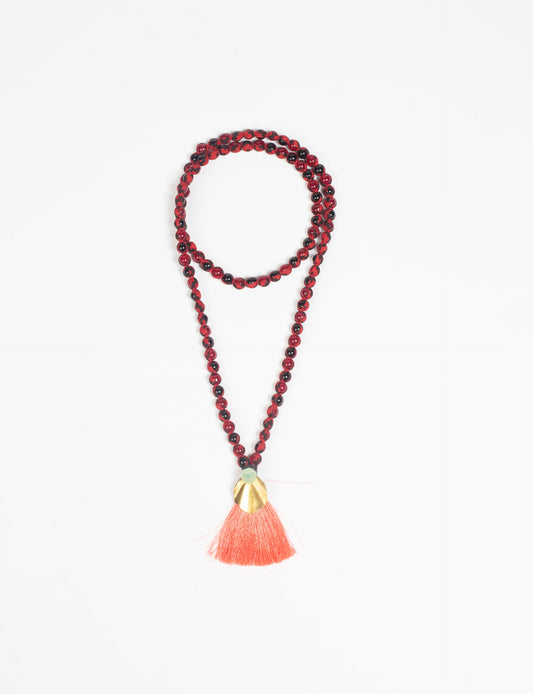 Discover elegance in our Beaded Tassel Necklace, meticulously handcrafted with glass beads, a silk tassel, and a metallic pendant. Hypoallergenic metal hooks provide a skin-friendly and stylish accessory. Length: 57 cm / 22.5 inches.