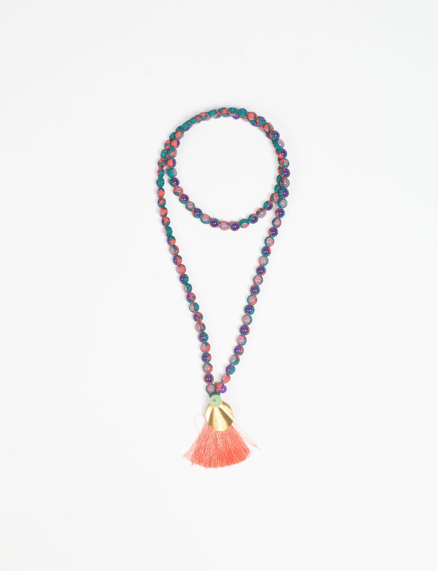 Discover elegance in our Beaded Tassel Necklace, meticulously handcrafted with glass beads, a silk tassel, and a metallic pendant. Hypoallergenic metal hooks provide a skin-friendly and stylish accessory. Length: 57 cm / 22.5 inches.