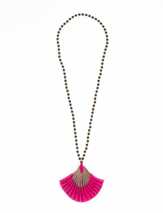 Dive into sustainable fashion with our PLEATED NECKLACE, a creation by talented female artisans in Mumbai. The pleated fan pendant, made from upcycled saris, hangs on a colorful necklace crafted from glass beads, embellished with sparkling glass crystals. An ethical, green fashion statement for conscious styling.