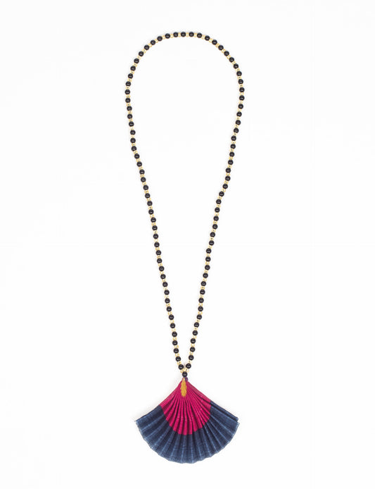 Dive into sustainable fashion with our PLEATED NECKLACE, a creation by talented female artisans in Mumbai. The pleated fan pendant, made from upcycled saris, hangs on a colorful necklace crafted from glass beads, embellished with sparkling glass crystals. An ethical, green fashion statement for conscious styling.