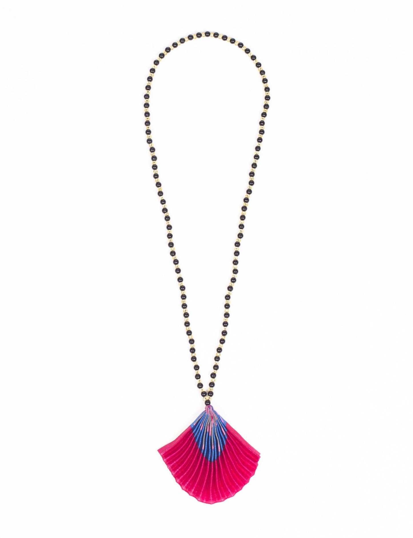 Dive into sustainable fashion with our PLEATED NECKLACE, a creation by talented female artisans in Mumbai. The pleated fan pendant, made from upcycled saris, hangs on a colorful necklace crafted from glass beads, embellished with sparkling glass crystals. An ethical, green fashion statement for conscious styling.