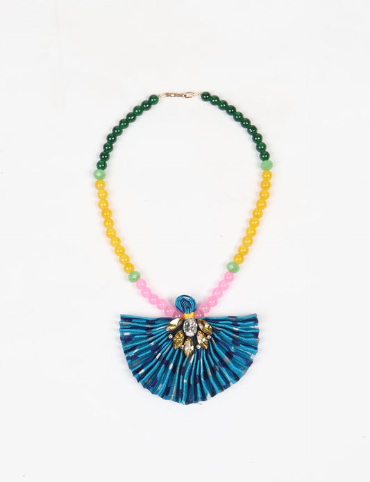 Dive into sustainable fashion with our PLEATED NECKLACE, a creation by talented female artisans in Mumbai. The pleated fan pendant, made from upcycled saris, hangs on a colorful necklace crafted from glass beads, embellished with sparkling glass crystals. An ethical, green fashion statement for conscious styling.