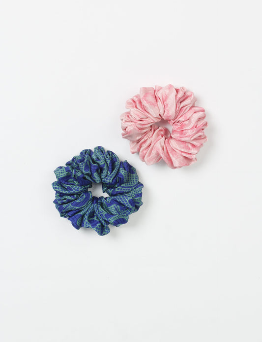 Upgrade your hairstyle with our Scrunchy Set of 2 – elastic hair ties wrapped in colorful Indian sari fabric. A top pick in ethical and green fashion, these eco-friendly prints add flair to your wrist and hair, making a sustainable style statement that catches attention and sparks change.