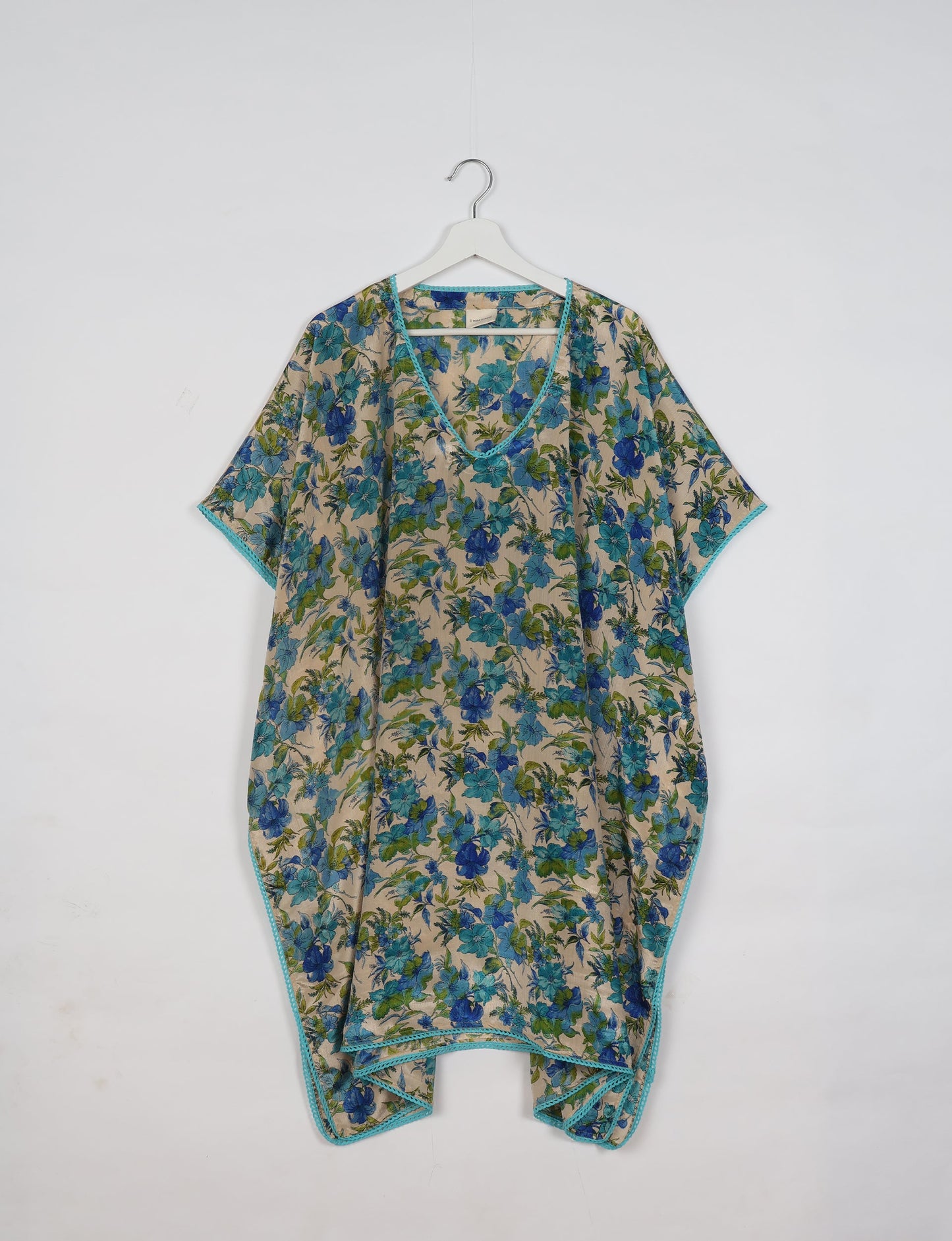 Embrace timeless elegance with our MIDI WRAP DRESS – a midi-length beauty featuring a v-neck, flattery from all angles, and a charming sari belt. Crafted from sustainable materials, this dress embodies ethical clothing and green fashion. Sophisticated with a frill tier at the hem and short cap sleeves, this dress is perfect for any occasion. Tie up the beautifully crafted sari belt on the side for a versatile, stylish, and eco-friendly look.