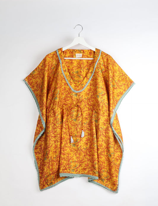 Elevate your style with our short kaftan, a perfect blend of ethical and green fashion. The light and loose-flowing fabric, drawstring waist, beaded tassel ends, and delicate lace edging make it a versatile choice for urban summers, beachwear, or poolside elegance. Enjoy sustainable and fashionable living.