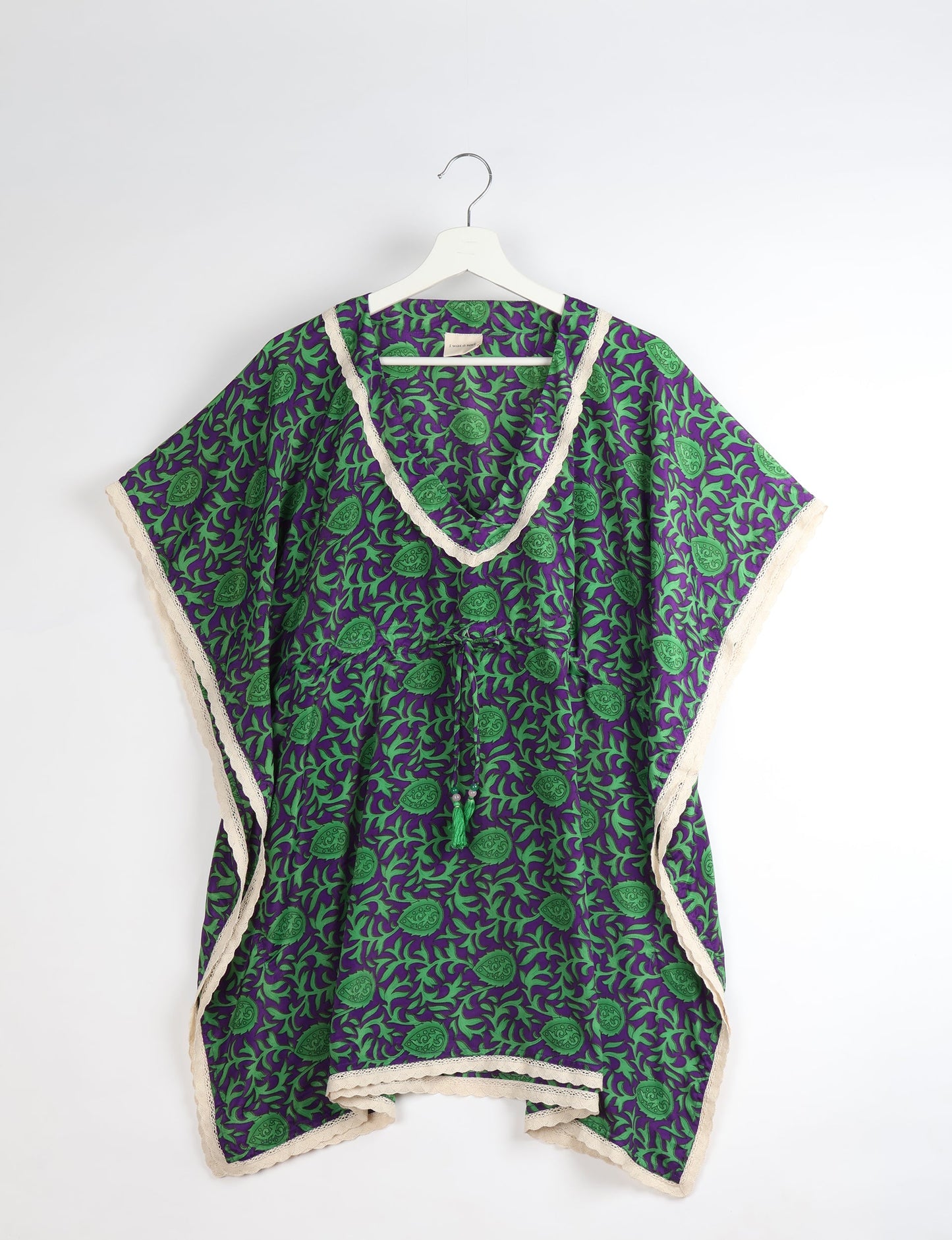 Elevate your style with our short kaftan, a perfect blend of ethical and green fashion. The light and loose-flowing fabric, drawstring waist, beaded tassel ends, and delicate lace edging make it a versatile choice for urban summers, beachwear, or poolside elegance. Enjoy sustainable and fashionable living.