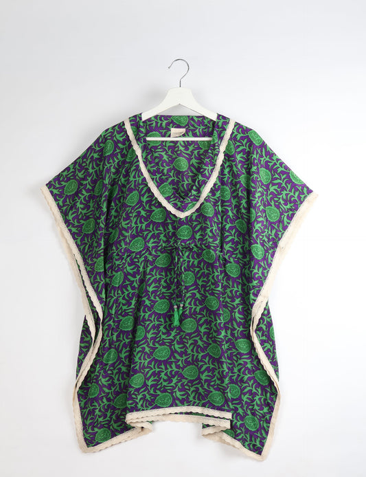 Elevate your style with our short kaftan, a perfect blend of ethical and green fashion. The light and loose-flowing fabric, drawstring waist, beaded tassel ends, and delicate lace edging make it a versatile choice for urban summers, beachwear, or poolside elegance. Enjoy sustainable and fashionable living.