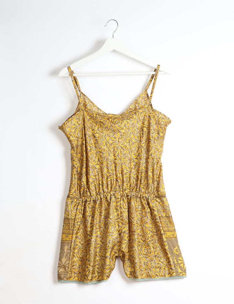 Yellow floral playsuit with lace trim, spaghetti straps, and elastic waist, hanging on white hanger, front view