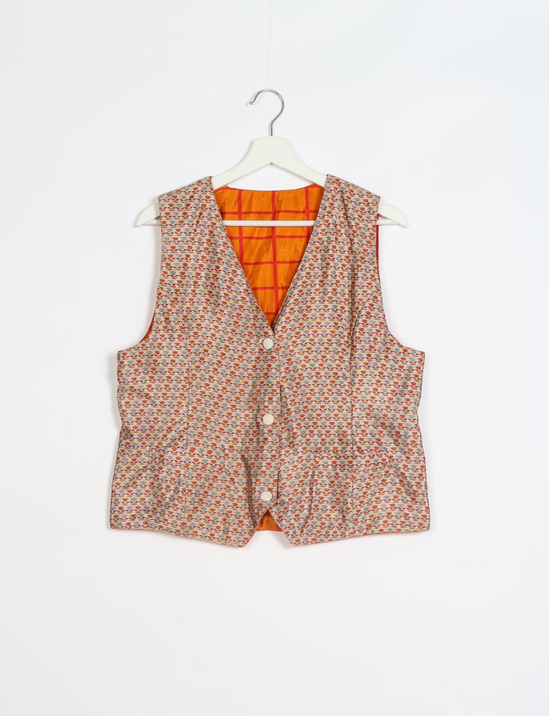 Beige waistcoat with small multicolor floral pattern, front buttons, and orange checkered inner lining, hanging on white hanger
