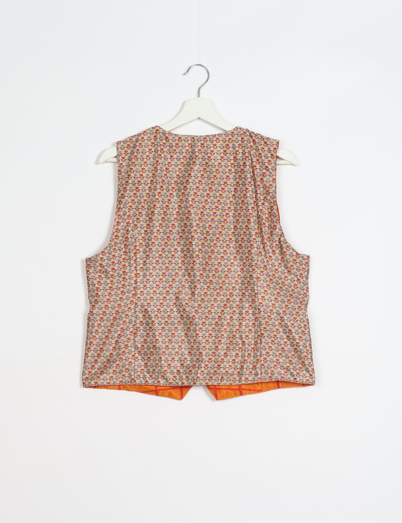 Beige waistcoat with small multicolor floral pattern, sleeveless, shown from back on white hanger against white background