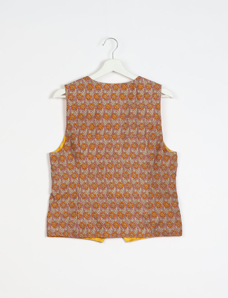 Brown floral patterned sleeveless waistcoat hanging on a white hanger against a white background