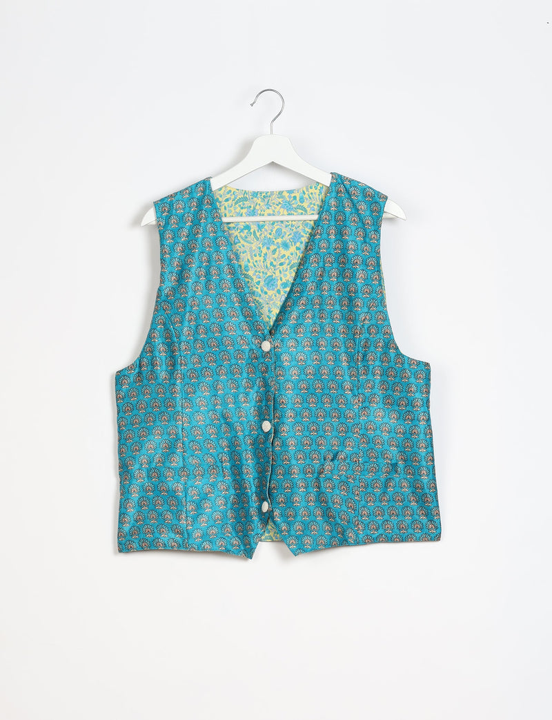 Blue waistcoat with micro floral design, button front, and contrasting floral inner lining, hanging on white hanger
