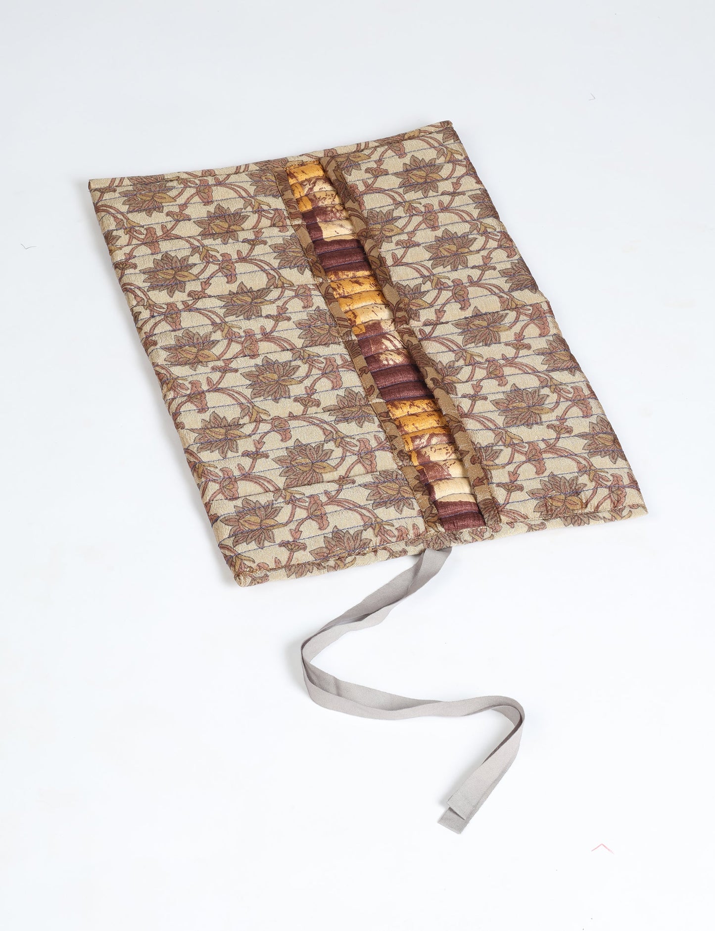 Roll-Up Organizer made from repurposed sari fabric, showcasing compact design and sustainable fashion innovation.