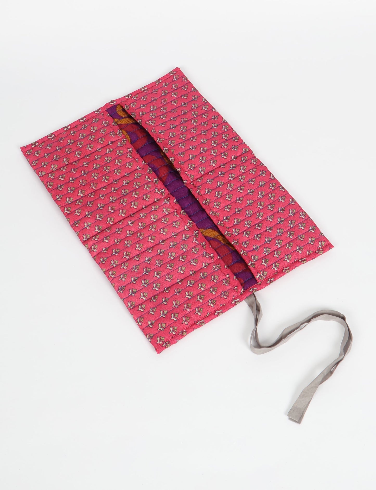 Roll-Up Organizer made from repurposed sari fabric, showcasing compact design and sustainable fashion innovation.