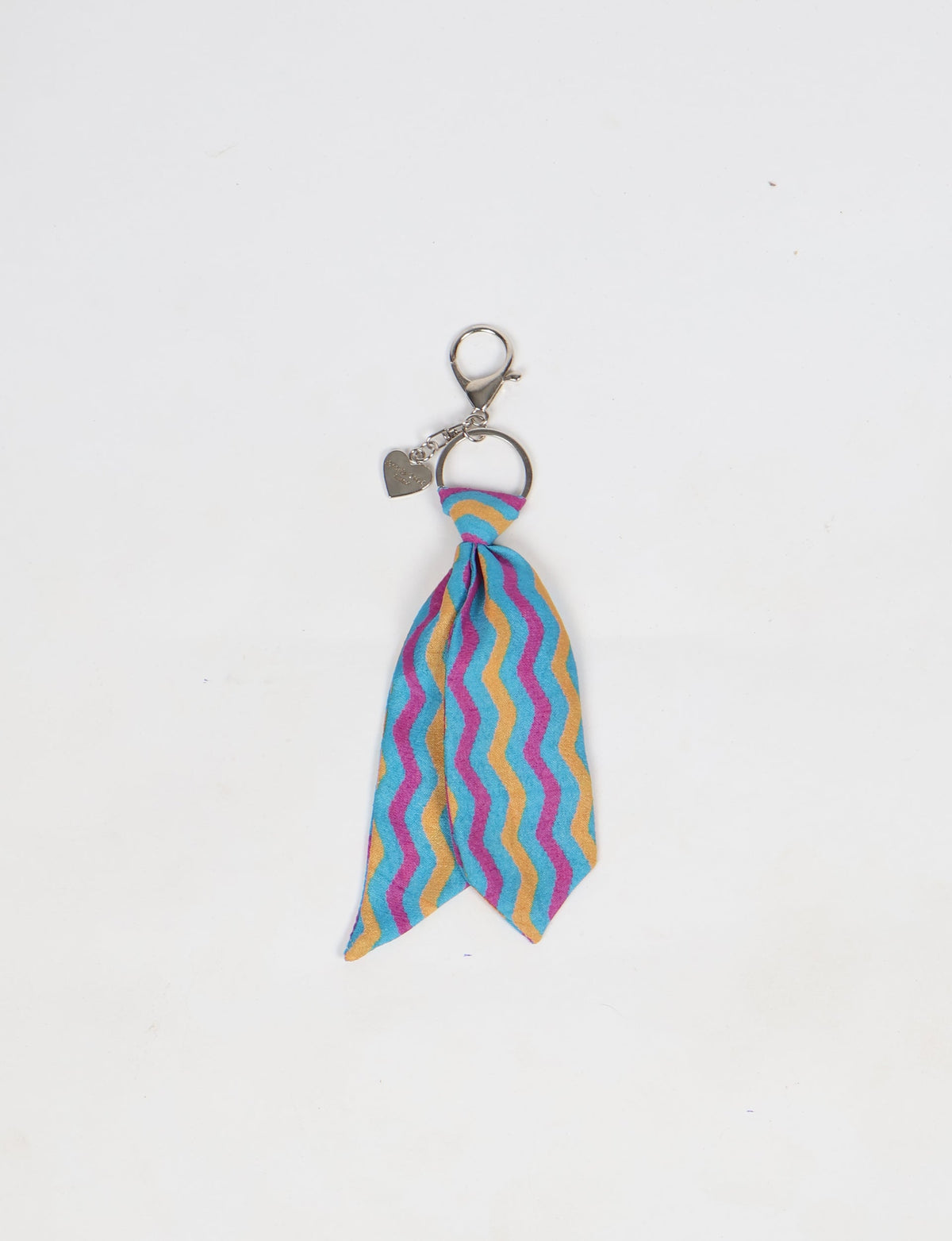 Blue, yellow, and pink wavy striped fabric tie keychain with silver ring and heart-shaped charm on white background