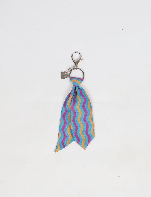Upcycled sari tie keychain with loop detail, made from recycled fashion waste in vibrant prints—eco clothing accessory for green fashion lovers, promoting slow fashion, recycled material clothing, and climate neutral fashion.