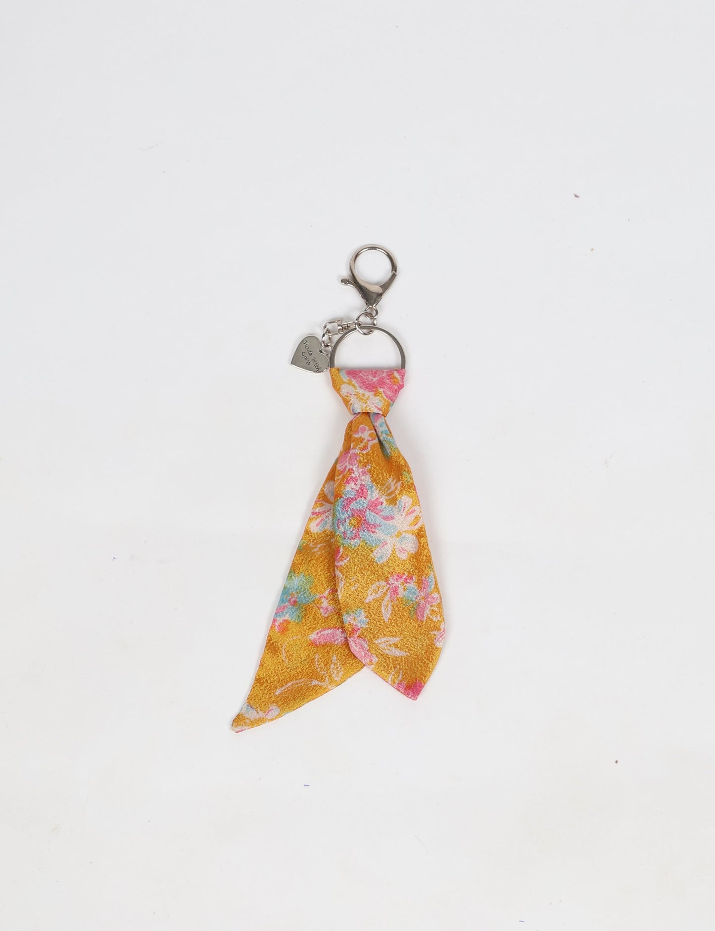 Upcycled sari tie keychain with loop detail, made from recycled fashion waste in vibrant prints—eco clothing accessory for green fashion lovers, promoting slow fashion, recycled material clothing, and climate neutral fashion.