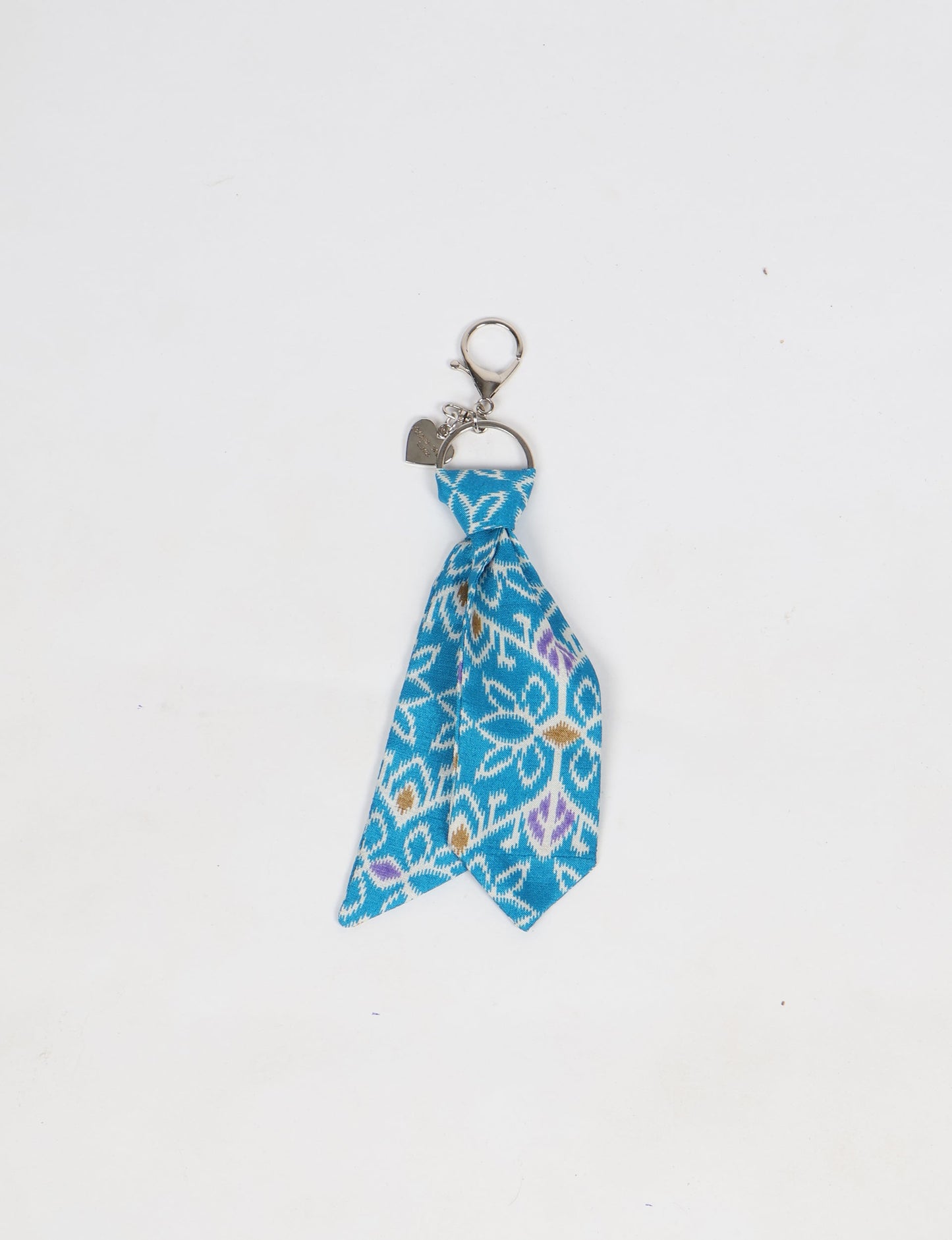 Upcycled sari tie keychain with loop detail, made from recycled fashion waste in vibrant prints—eco clothing accessory for green fashion lovers, promoting slow fashion, recycled material clothing, and climate neutral fashion.