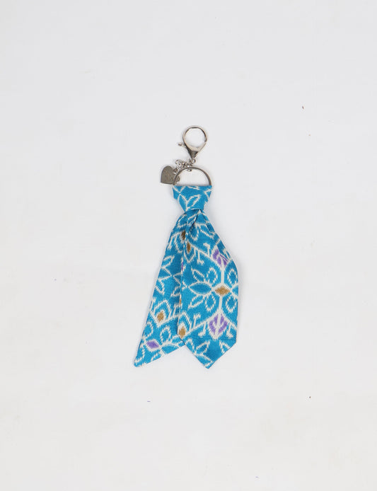 Upcycled sari tie keychain with loop detail, made from recycled fashion waste in vibrant prints—eco clothing accessory for green fashion lovers, promoting slow fashion, recycled material clothing, and climate neutral fashion.