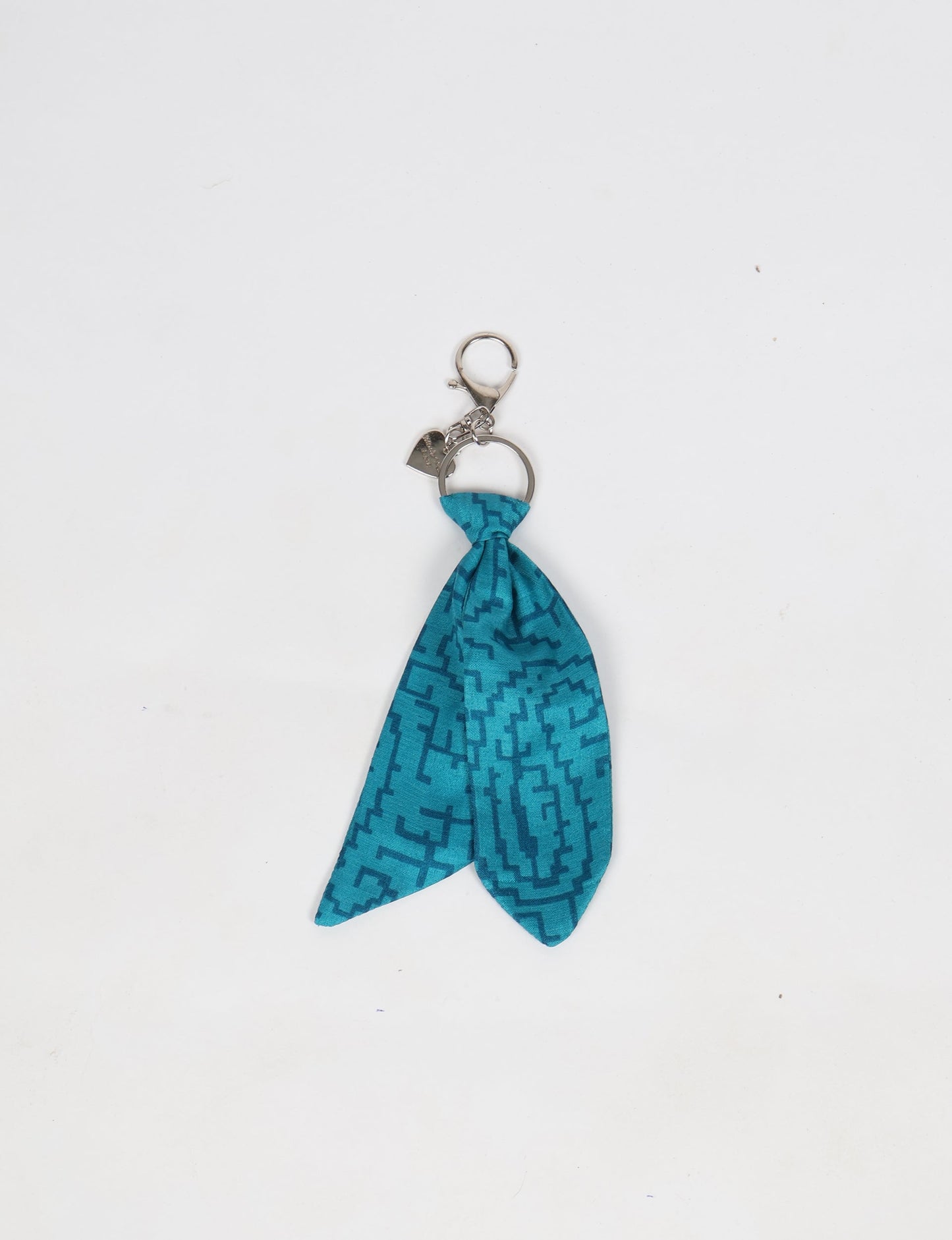 Upcycled sari tie keychain with loop detail, made from recycled fashion waste in vibrant prints—eco clothing accessory for green fashion lovers, promoting slow fashion, recycled material clothing, and climate neutral fashion.