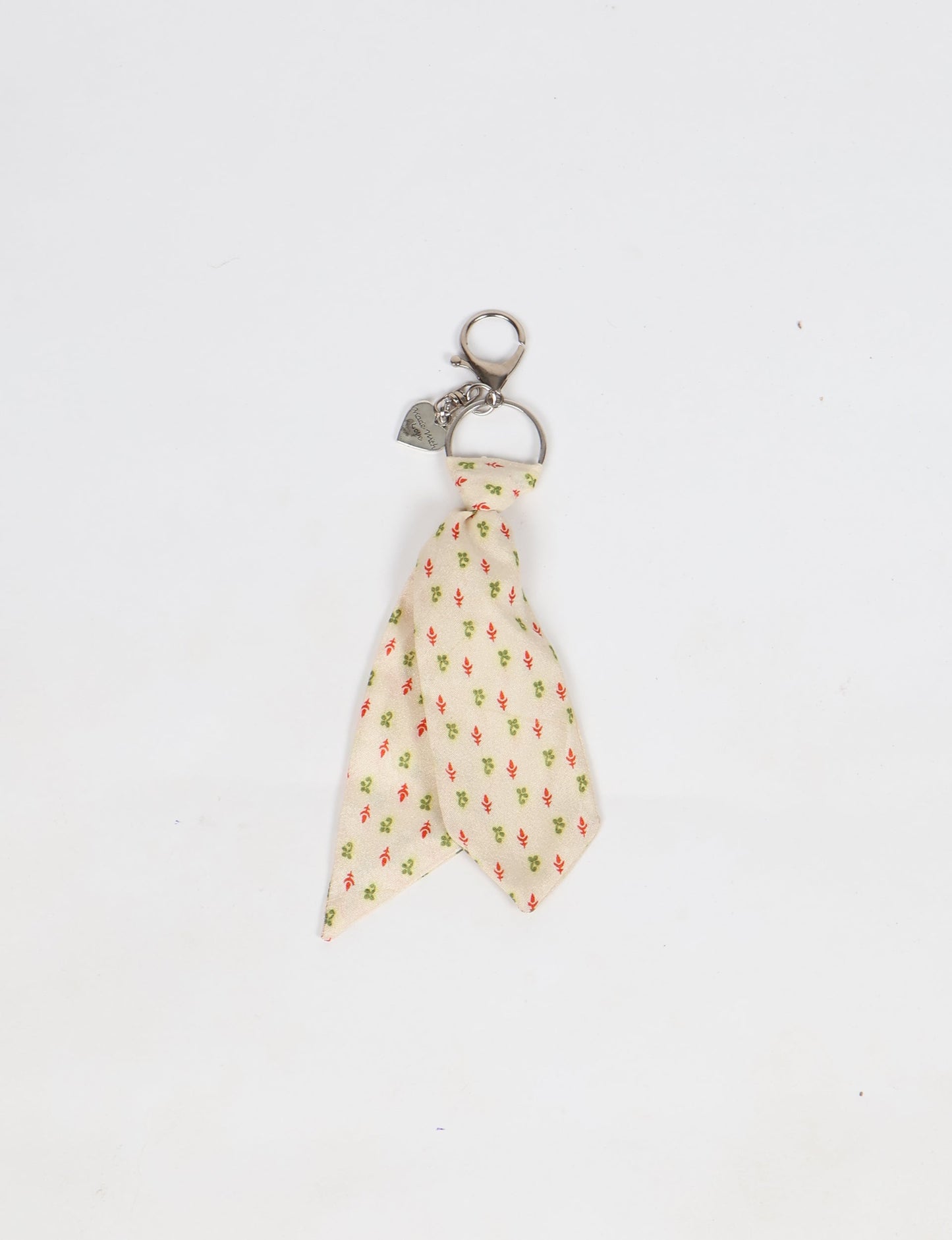 Upcycled sari tie keychain with loop detail, made from recycled fashion waste in vibrant prints—eco clothing accessory for green fashion lovers, promoting slow fashion, recycled material clothing, and climate neutral fashion.
