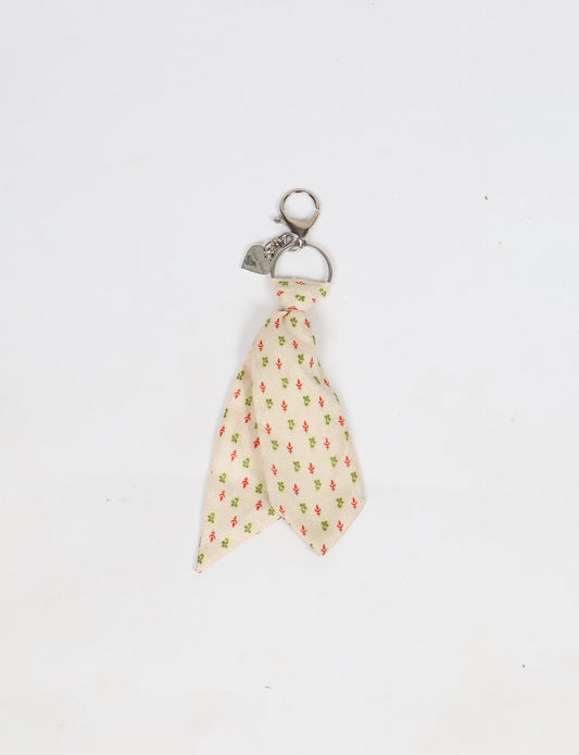 Upcycled sari tie keychain with loop detail, made from recycled fashion waste in vibrant prints—eco clothing accessory for green fashion lovers, promoting slow fashion, recycled material clothing, and climate neutral fashion.