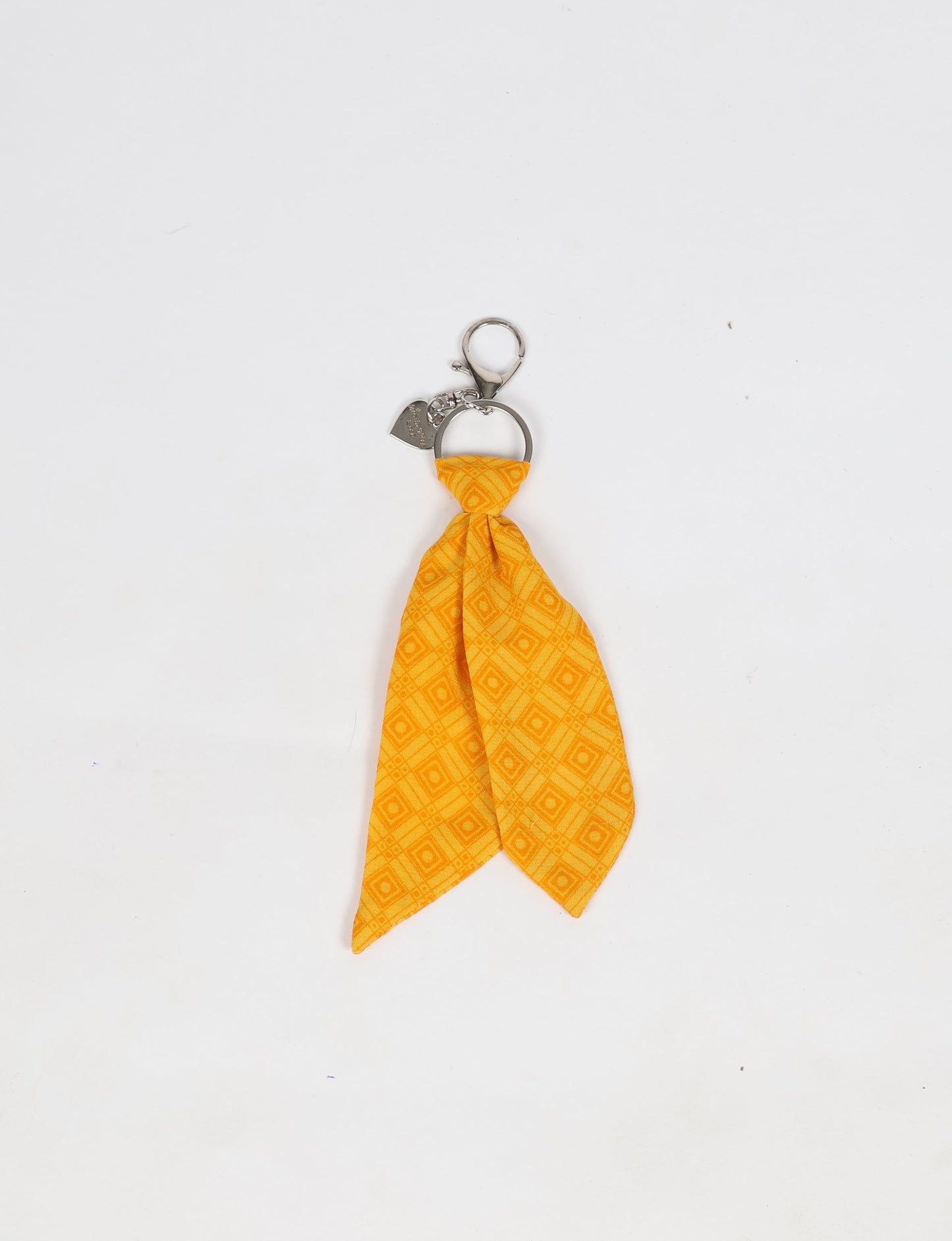 Upcycled sari tie keychain with loop detail, made from recycled fashion waste in vibrant prints—eco clothing accessory for green fashion lovers, promoting slow fashion, recycled material clothing, and climate neutral fashion.