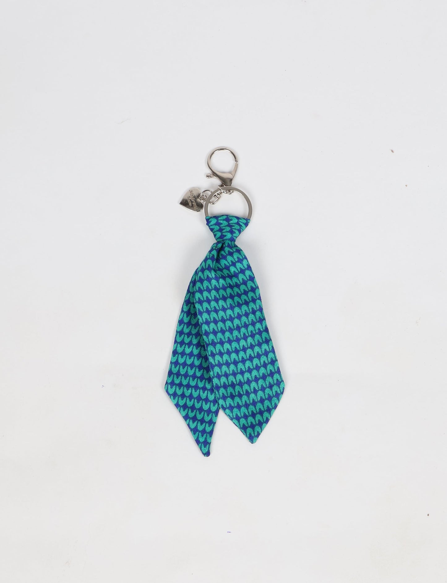 Upcycled sari tie keychain with loop detail, made from recycled fashion waste in vibrant prints—eco clothing accessory for green fashion lovers, promoting slow fashion, recycled material clothing, and climate neutral fashion.