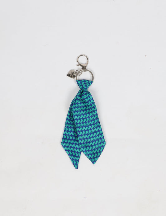 Upcycled sari tie keychain with loop detail, made from recycled fashion waste in vibrant prints—eco clothing accessory for green fashion lovers, promoting slow fashion, recycled material clothing, and climate neutral fashion.