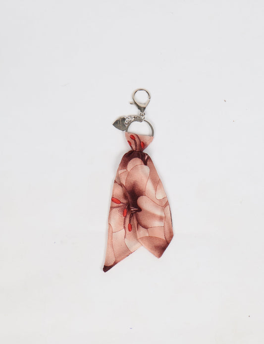 Upcycled sari tie keychain with loop detail, made from recycled fashion waste in vibrant prints—eco clothing accessory for green fashion lovers, promoting slow fashion, recycled material clothing, and climate neutral fashion.