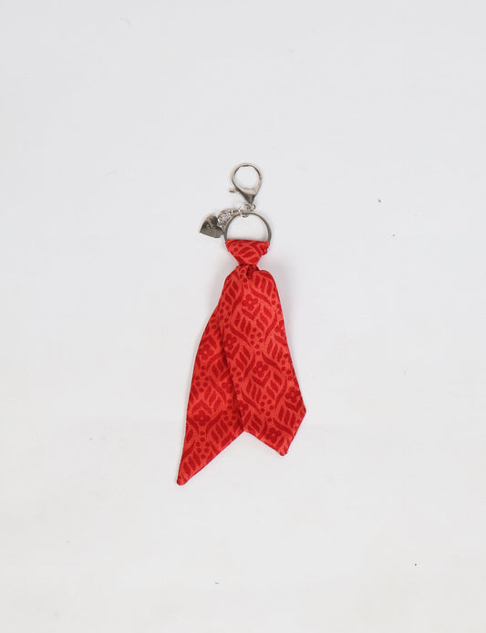 Upcycled sari tie keychain with loop detail, made from recycled fashion waste in vibrant prints—eco clothing accessory for green fashion lovers, promoting slow fashion, recycled material clothing, and climate neutral fashion.