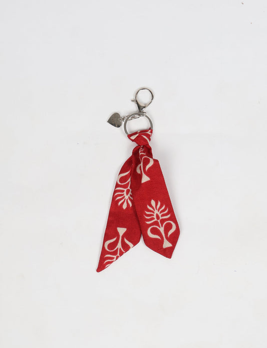 Upcycled sari tie keychain with loop detail, made from recycled fashion waste in vibrant prints—eco clothing accessory for green fashion lovers, promoting slow fashion, recycled material clothing, and climate neutral fashion.