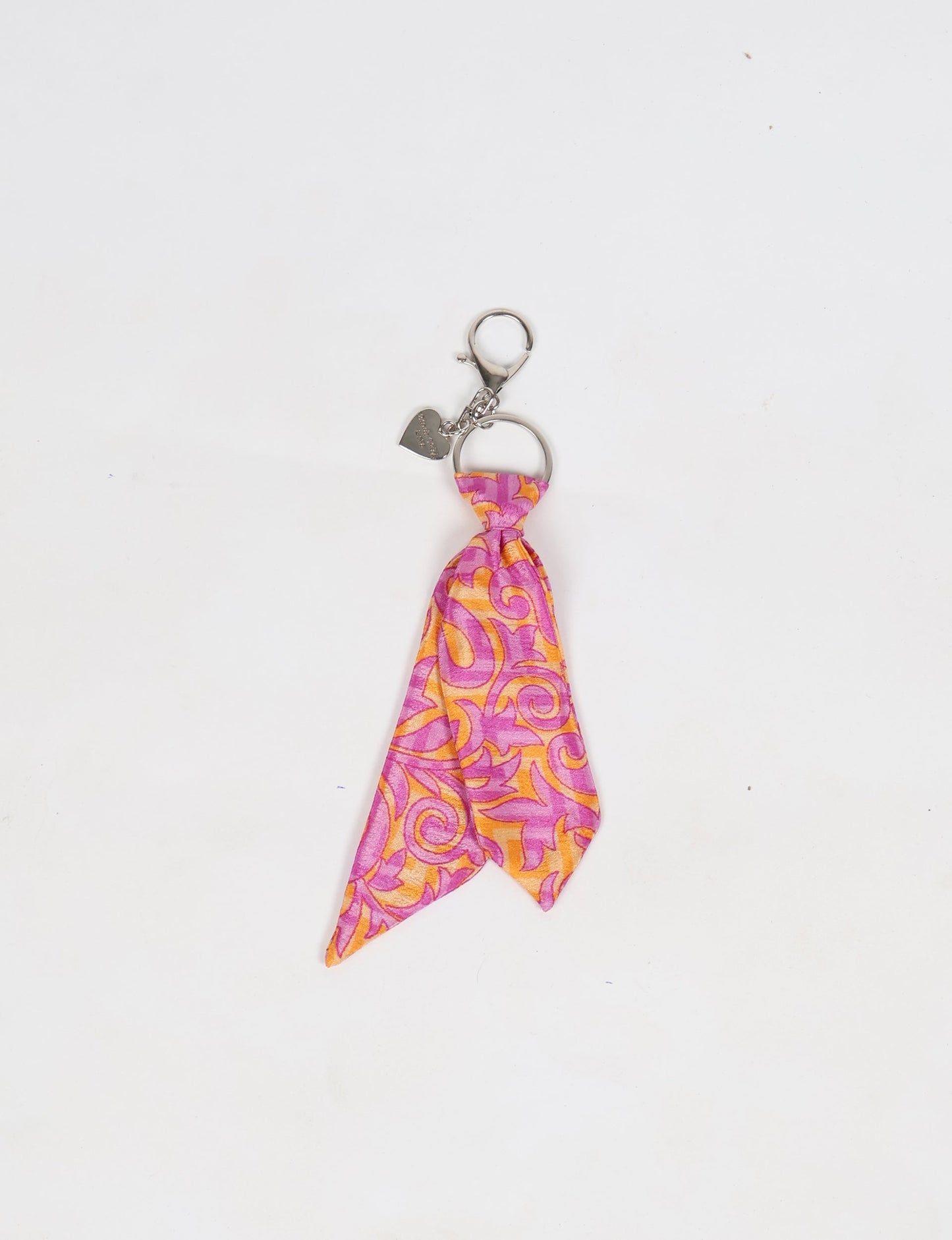Upcycled sari tie keychain with loop detail, made from recycled fashion waste in vibrant prints—eco clothing accessory for green fashion lovers, promoting slow fashion, recycled material clothing, and climate neutral fashion.