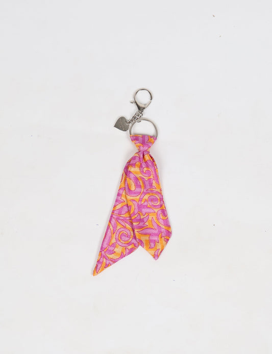 Upcycled sari tie keychain with loop detail, made from recycled fashion waste in vibrant prints—eco clothing accessory for green fashion lovers, promoting slow fashion, recycled material clothing, and climate neutral fashion.