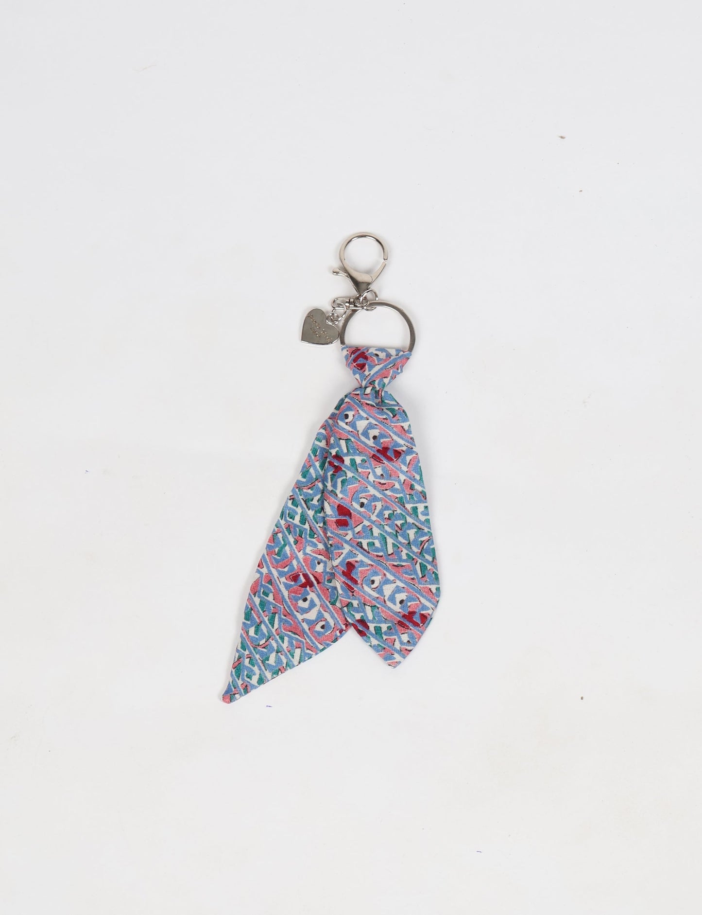 Upcycled sari tie keychain with loop detail, made from recycled fashion waste in vibrant prints—eco clothing accessory for green fashion lovers, promoting slow fashion, recycled material clothing, and climate neutral fashion.