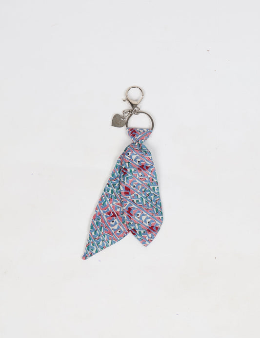 Upcycled sari tie keychain with loop detail, made from recycled fashion waste in vibrant prints—eco clothing accessory for green fashion lovers, promoting slow fashion, recycled material clothing, and climate neutral fashion.