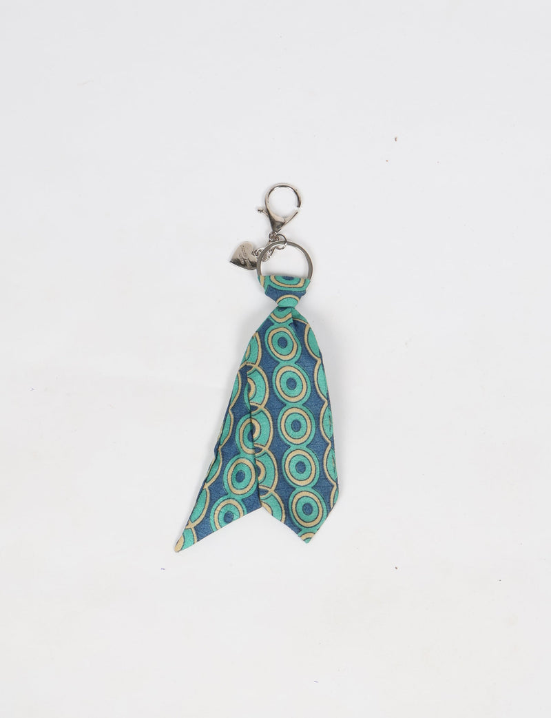 Keychain with a small blue and green patterned tie and a silver lobster clasp and heart charm on a white background