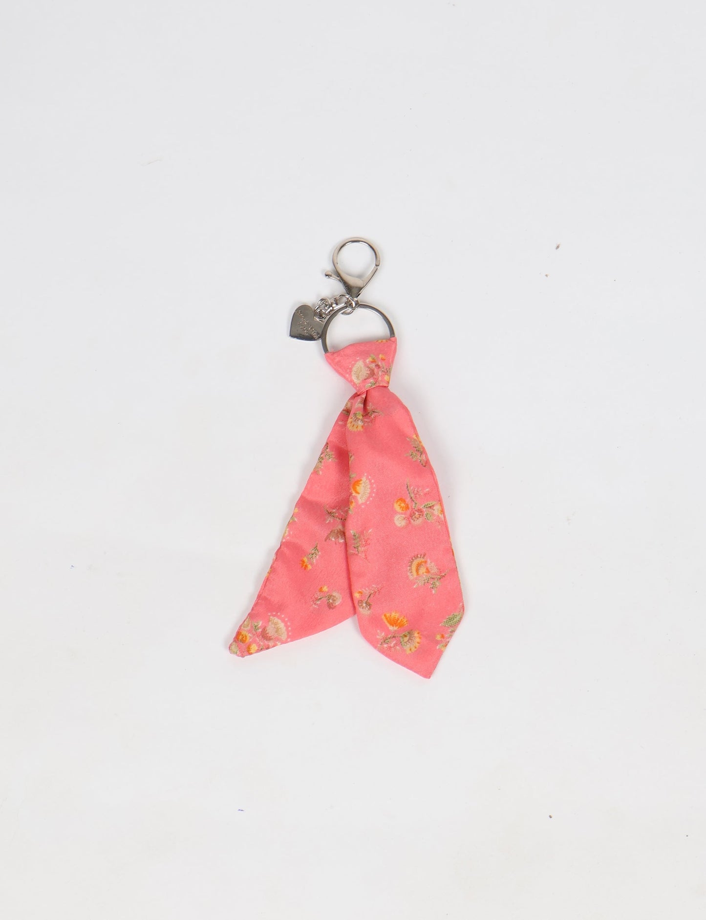 Upcycled sari tie keychain with loop detail, made from recycled fashion waste in vibrant prints—eco clothing accessory for green fashion lovers, promoting slow fashion, recycled material clothing, and climate neutral fashion.
