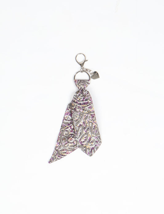 Upcycled sari tie keychain with loop detail, made from recycled fashion waste in vibrant prints—eco clothing accessory for green fashion lovers, promoting slow fashion, recycled material clothing, and climate neutral fashion.