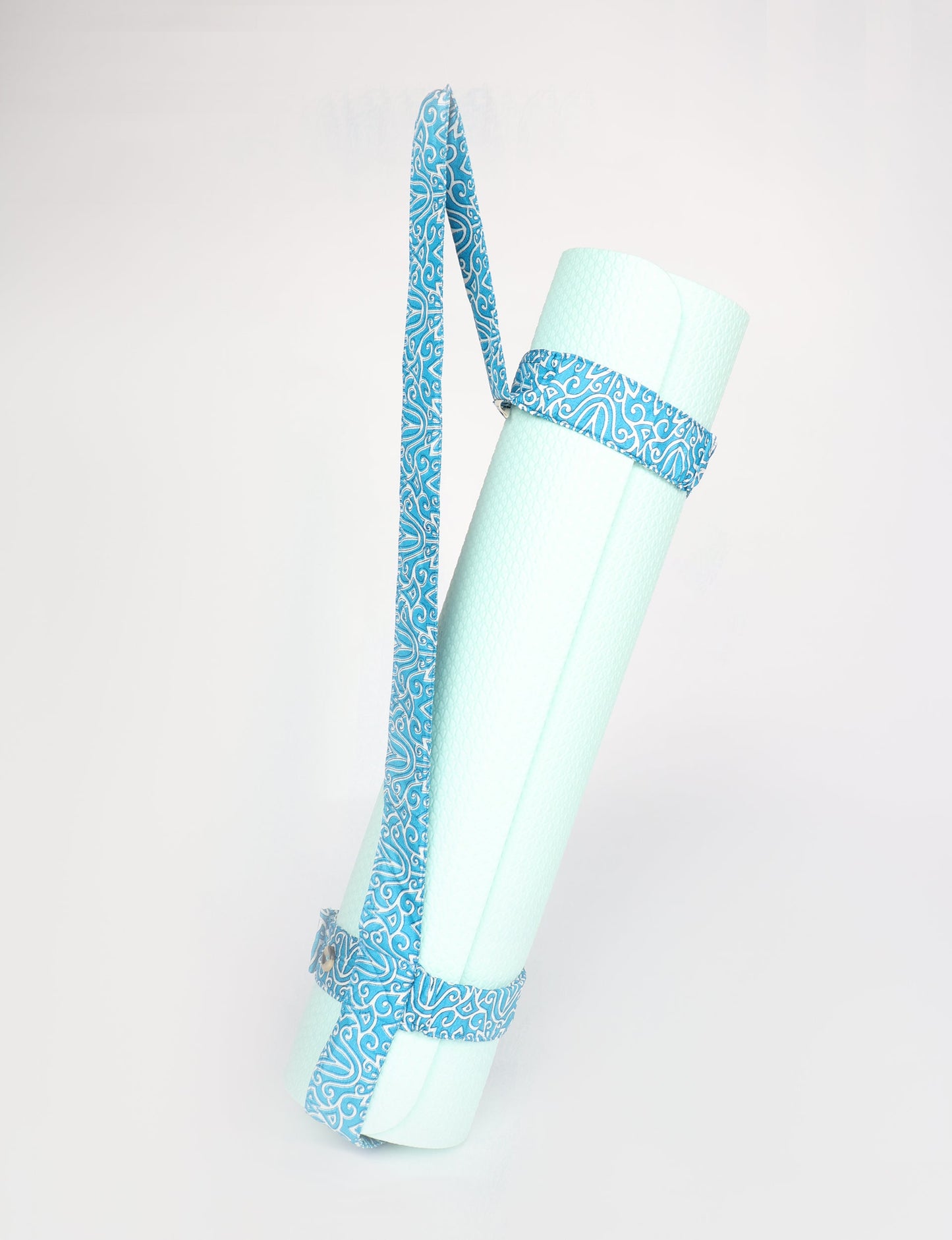 A green yoga mat holder made from upcycled materials, embodying ethical and sustainable fashion ideals.