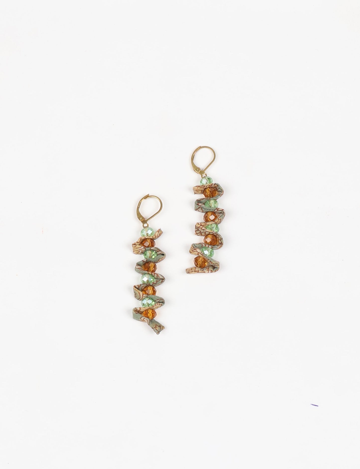 Wavy Dangler Earrings made from upcycled materials, showcasing eco-friendly fashion and sustainable women's clothing. A delicate blend of style and environmentally friendly design, perfect for those who value conscious clothing and circular fashion.