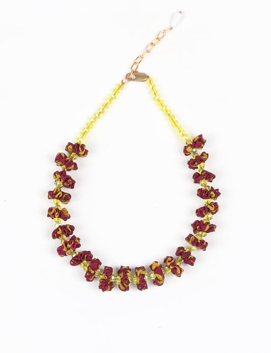 Floret Necklace with vibrant beaded accents, designed from recycled materials, embodying upcycled women’s clothing and green fashion ideals. Perfect eco-friendly fashion accessory for sustainable apparel enthusiasts.
