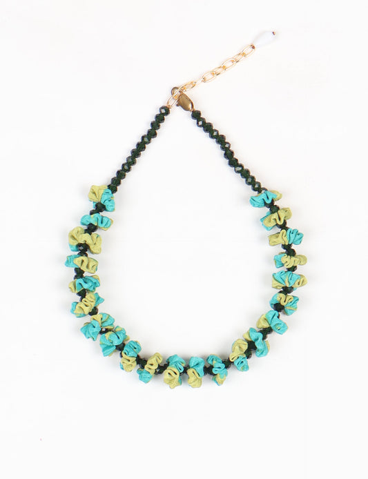 Floret Necklace with vibrant beaded accents, designed from recycled materials, embodying upcycled women’s clothing and green fashion ideals. Perfect eco-friendly fashion accessory for sustainable apparel enthusiasts.