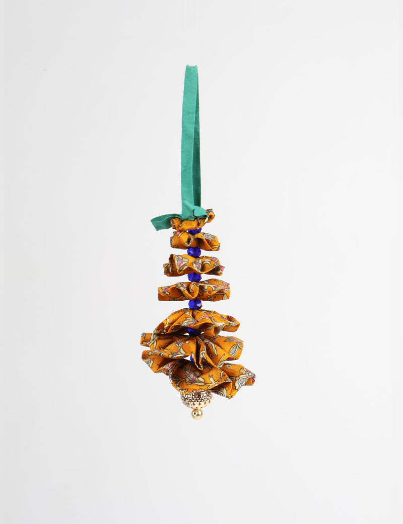 Yellow fabric Christmas tree ornament with abstract pattern, blue beads, gold bell, and green hanging loop, front view