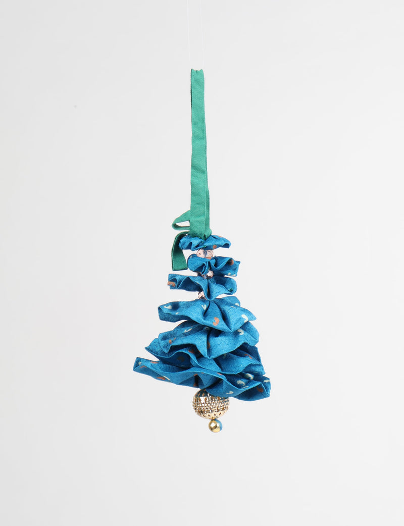 Blue fabric Christmas tree ornament with abstract pattern, green hanging loop, and gold bead at the bottom, front view
