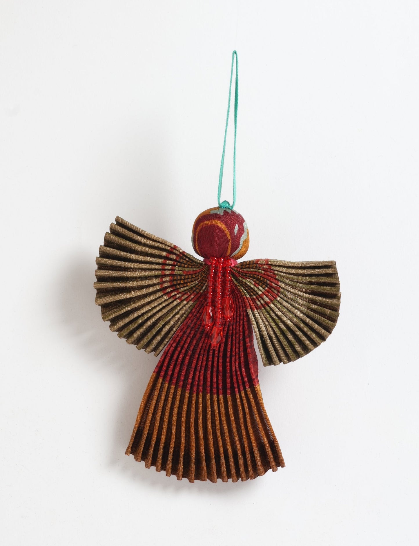 Angel Christmas Ornament made from upcycled saris, featuring pleated arms and body. A sustainable, eco-friendly holiday decoration, embodying recycled fashion and upcycling in festive style.





