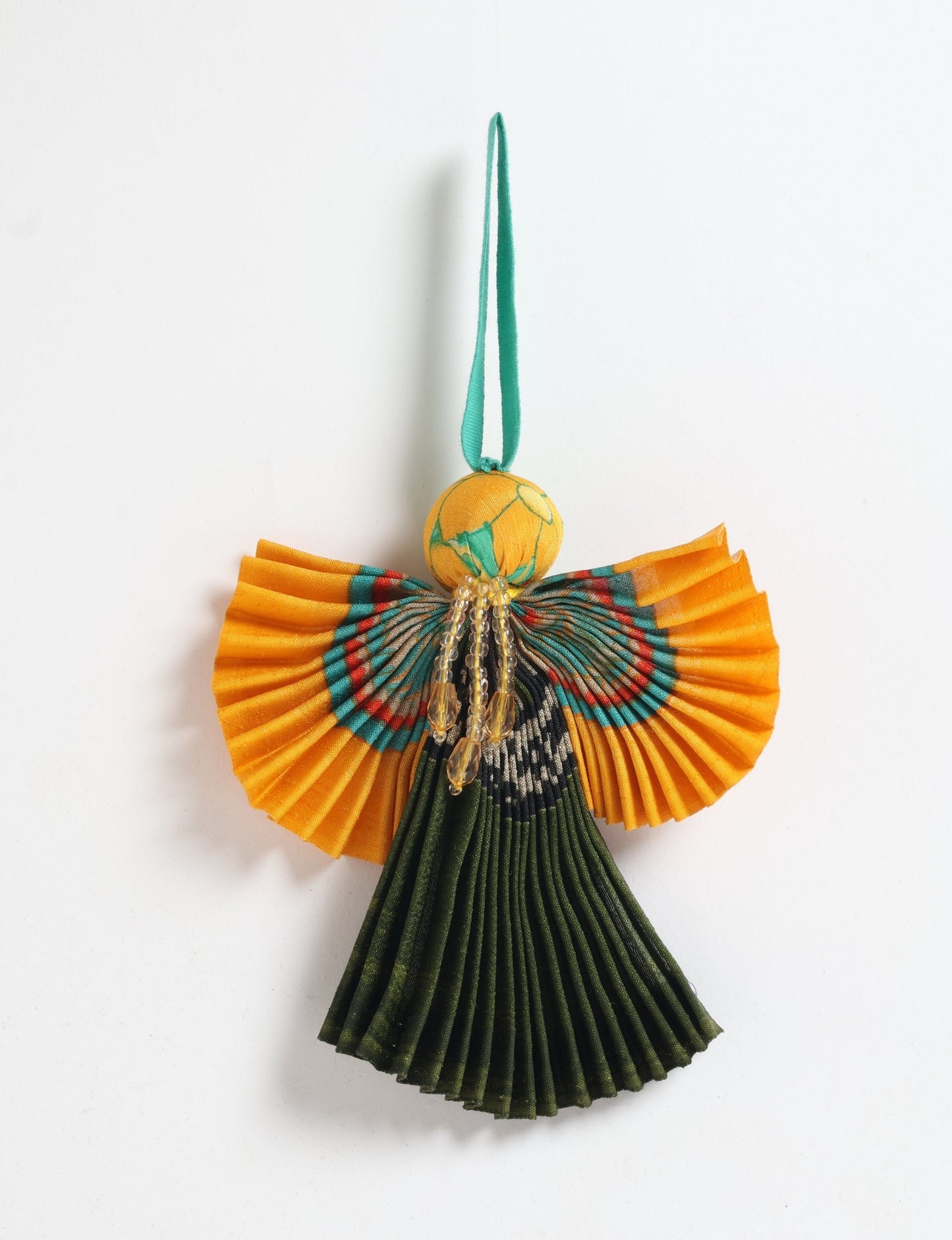 Angel Christmas Ornament made from upcycled saris, featuring pleated arms and body. A sustainable, eco-friendly holiday decoration, embodying recycled fashion and upcycling in festive style.





