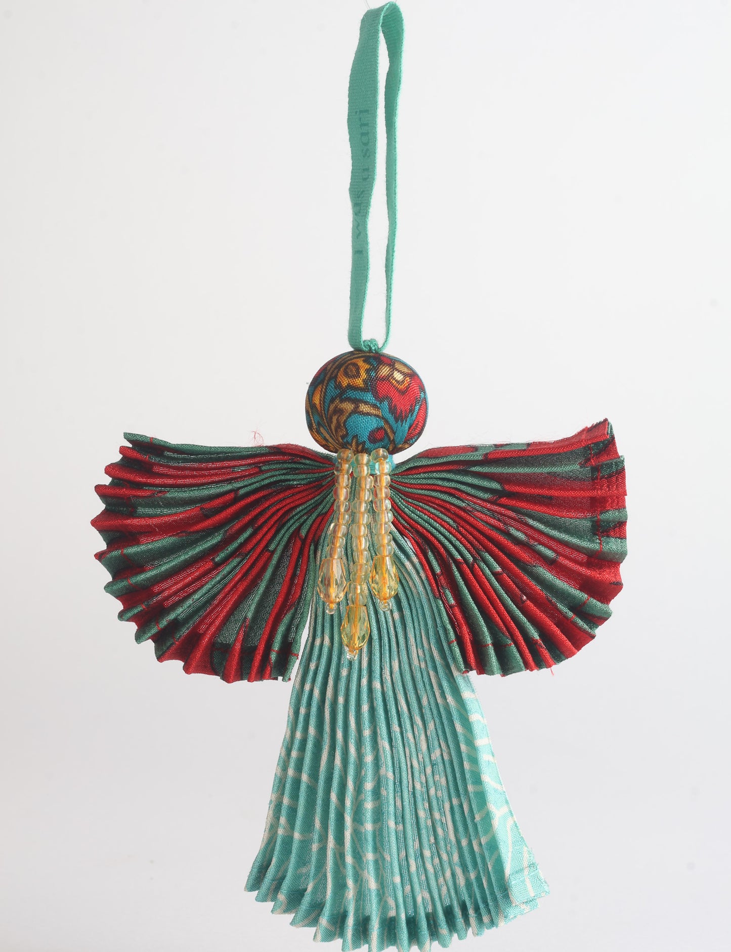 Angel Christmas Ornament made from upcycled saris, featuring pleated arms and body. A sustainable, eco-friendly holiday decoration, embodying recycled fashion and upcycling in festive style.





